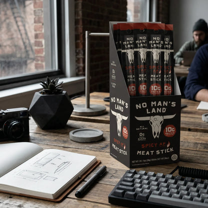 No Man's Land Spicy Meat Stick Spicy AF packaging on a desk with a person in the background